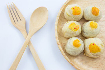 Chinese Pastry Mung Bean or Mooncake with Egg Yolk on wooden dish and spoon fork