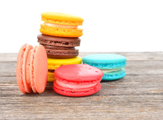 close up of colorful macarons on wooden texture