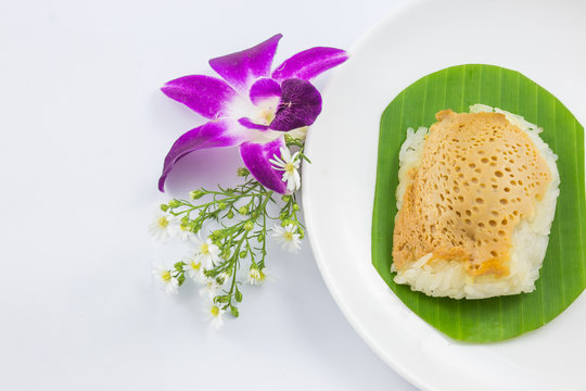 sticky rice with steamed custard on banana leaves and dish with orchid flower, sweet sticky rice, Thai sweet dessert, original Thai food