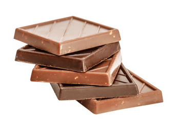 Cut chunks of a milk and bitter chocolate bar isolated on white background