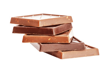 Cut chunks of a milk and bitter chocolate bar isolated on white background