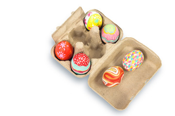 Colorful easter egg in pulp box on white background