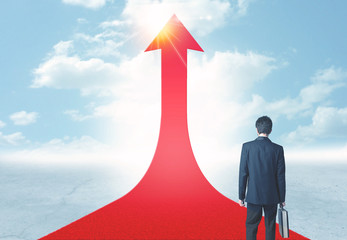 businessman standing on a red arrow