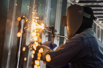 Worker and metal cutting with acetylene torch