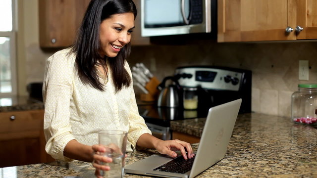 Woman using technology in kitchen