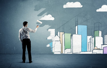 Salesman painting tall buildings on urban wall