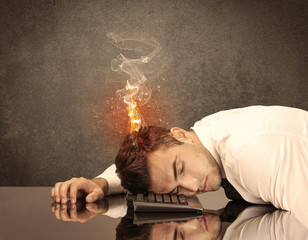 Sad business person's head catching fire