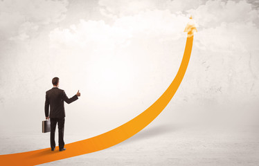 Business person standing on orange arrow