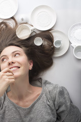 women lies on her back in a white dish