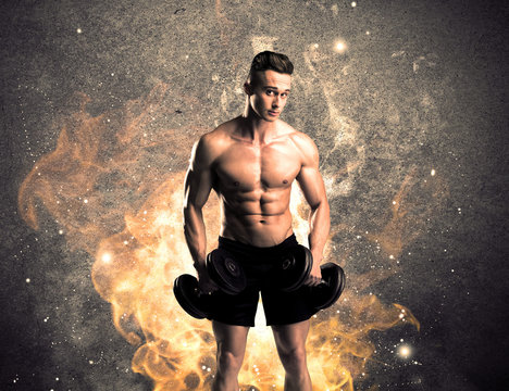 Healthy hot male showing muscles with fire