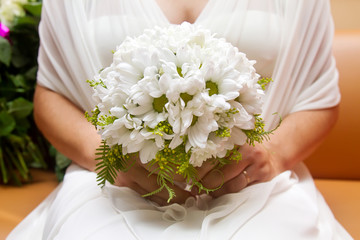 Beautiful wedding bouquet of flowers in bride's hands