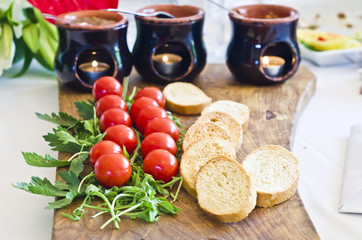 A delicious appetizer with cherry tomatoes, arugula and bruschetta