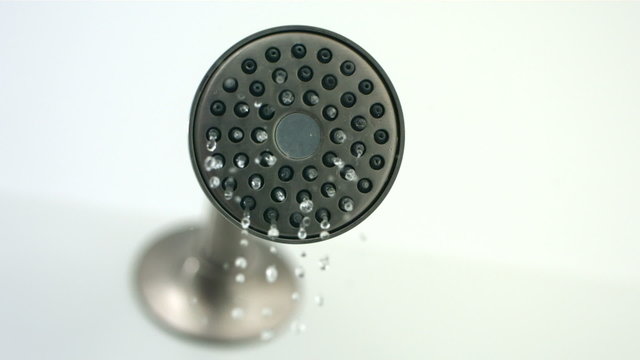 Water sprays out of shower head, slow motion