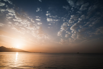 Dramatic colorful seascape. Sun, evening sky
