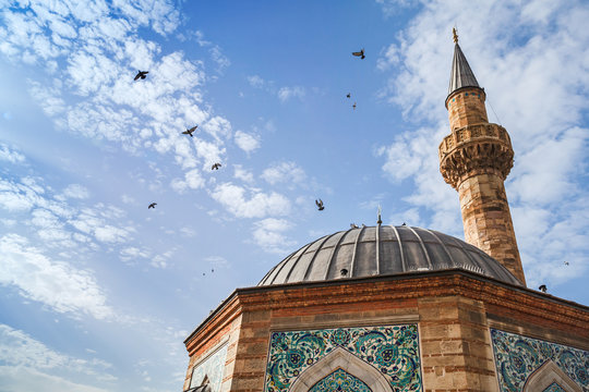 Doves fly over Ancient Camii mosque, Izmir