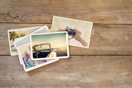 Travel photo album on wood table. instant photo of polaroid camera - vintage and retro style