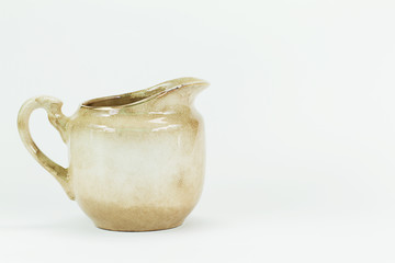 Old grunge vintage white ceramic milk jar isolated on white back