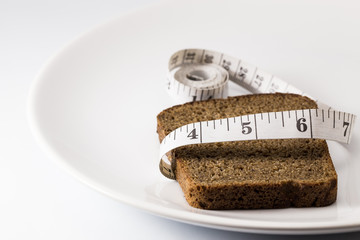 bread with flexible ruler on white plate