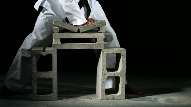 Karate chop breaks stack of bricks, slow motion