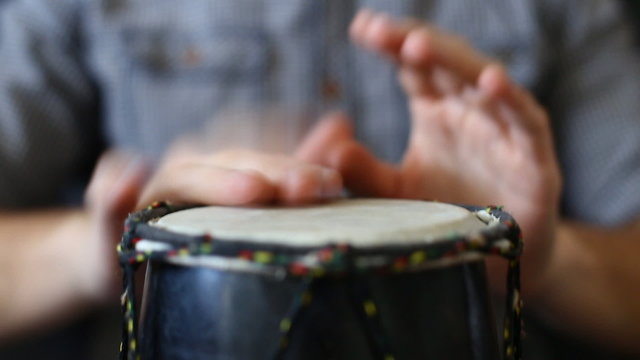 Playing Bongo drum close up HD stock footage. Hand tapping a Bongo drum in close up. 