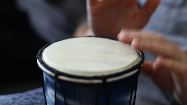 Playing Bongo drum close up HD stock footage. Hand tapping a Bongo drum in close up. 