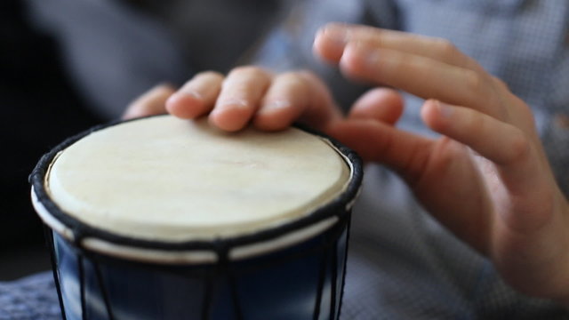 Playing Bongo drum close up HD stock footage. Hand tapping a Bongo drum in close up. 