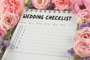 word wedding checklist note paper on pink flower background