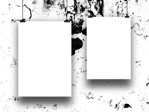Close-up of two hanged paper sheets with clips on black and white ink splotchy background
