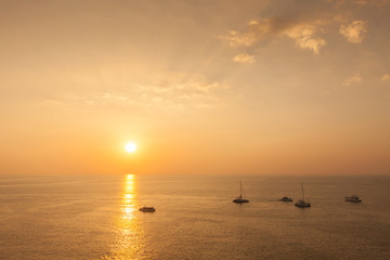 Yacht in the tropical sea at sunset