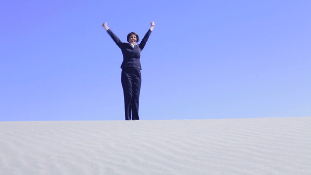 Woman celebrating in desert