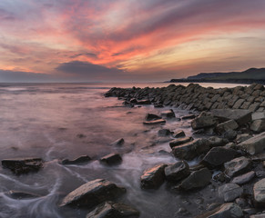 Fototapeta na wymiar Beautiful sunset landscape image of rocky coastline in Kimmeridg