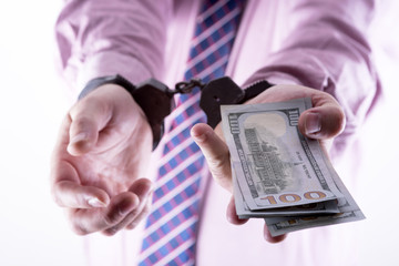 Crime and Money. Handcuffs are on the dollar
