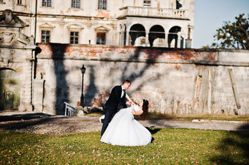 Wedding couple on sunny weather background wall with shadows old