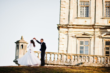 Charming and fashionable wedding couple in love background old v
