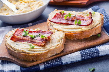 Spreads. Egg spread, grilled bacon, bread young basil leaves, Herb decoration. Ingredients: six eggs, spring onion, yeast, processed cheese, bacon, salt, pepper, various herbs decorations.