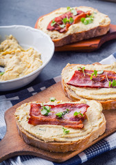 Spreads. Egg spread, grilled bacon, bread young basil leaves, Herb decoration. Ingredients: six eggs, spring onion, yeast, processed cheese, bacon, salt, pepper, various herbs decorations.