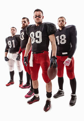 Fototapeta na wymiar The four american football players posing with ball on white background