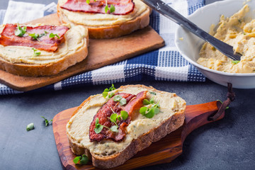 Spreads. Egg spread, grilled bacon, bread young basil leaves, Herb decoration. Ingredients: six eggs, spring onion, yeast, processed cheese, bacon, salt, pepper, various herbs decorations.