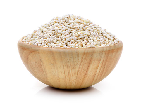 Barley Grains in the wood bowl  on white background