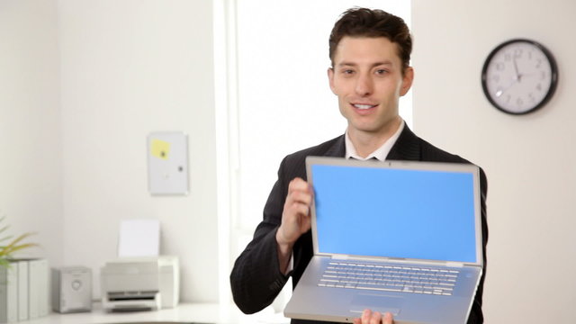 Businessman holds laptop computer
