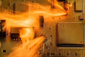 Burning circuit board with electronic components. Computer, technology, repair and fire protection concept. 
