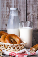 Milk and bagels on a wooden table