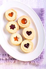 Jam filling linzer cookies on plate