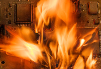 Burning circuit board with electronic components. Computer, technology, repair and fire protection...
