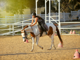Obraz premium young girl is riding a horse