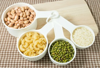 Pasta, Rice, Peanuts and Mung Beans in Measuring Spoons