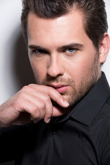 Portrait of handsome man in black shirt.