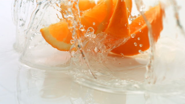 Citrus fruit splashing, slow motion