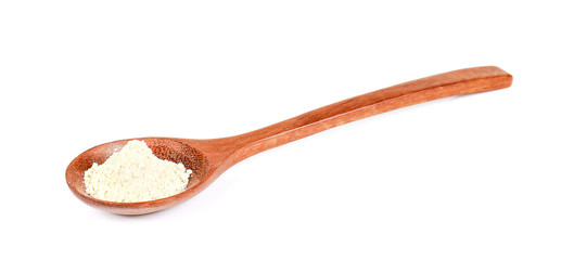 Wasabi powder in wooden spoon on white background.