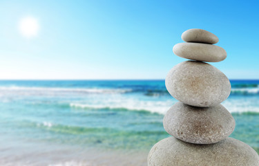 Fototapeta na wymiar Balanced stones, sunny sea scene 